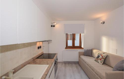 a living room with a couch and a kitchen at Baidoni Primo Piano in Ponte Caffaro