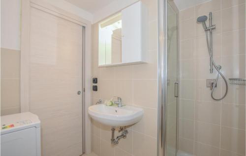 a white bathroom with a sink and a shower at Baidoni Primo Piano in Ponte Caffaro