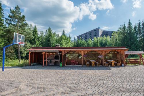 a pavilion with a basketball hoop in a park at Pensiunea Orizont in Poiana Brasov