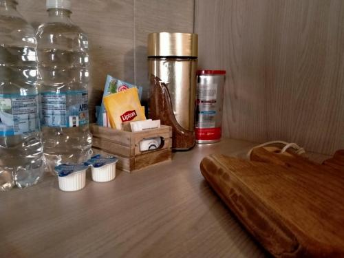 a table with a bottle of water and a wooden counter top at Casa Toscanella in Pescia