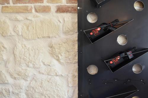 a table with wine bottles and rocks on it at Tenuta Micoli in Frisa