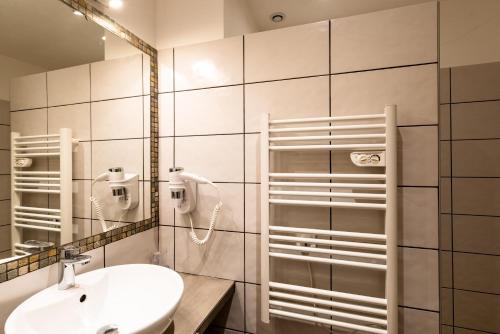 a bathroom with a sink and a mirror at Les Arcades de Cala Rossa in Lecci