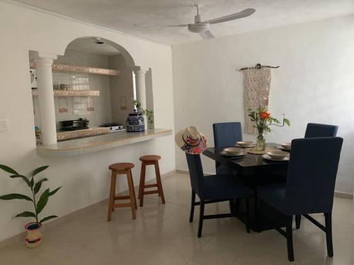 a dining room with a table and chairs and a kitchen at Private Full House with pool and cozy patio in Valladolid