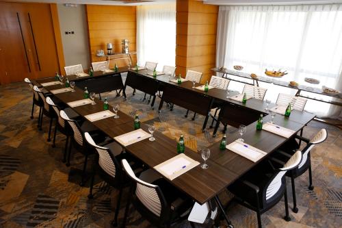 a large conference room with long tables and chairs at Grand Plaza Hotel - Jazan in Jazan