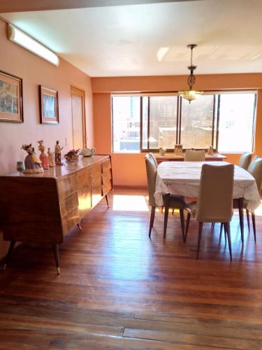 a dining room with a table and a table and chairs at Hostal La Posada De La Abuela in La Paz