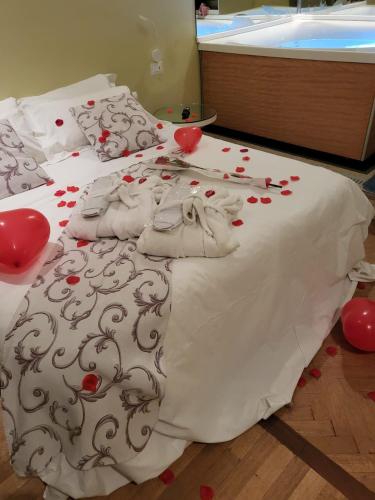 a bed with red hearts on top of it at HOTEL VILLA ISA in Pescara