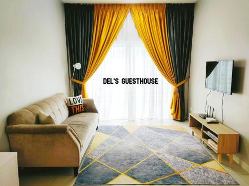 a living room with a couch and a television at Del’s Guesthouse @ Southville Same Level with Pool fits 8 in Bangi