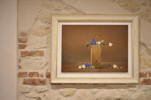 a picture of a cross with a bird on it at Tenuta Micoli in Frisa