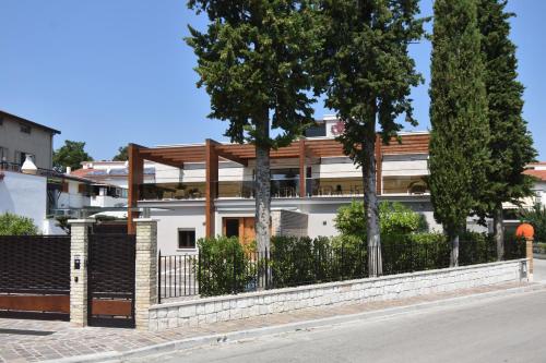 a white building with trees in front of it at Tenuta Micoli in Frisa