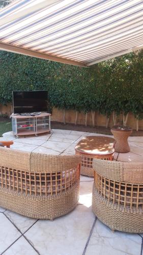 a patio with two wicker chairs and a table at Stella Di Mare Ain Sokhna Beautiful Luxurious Villa in Ain Sokhna