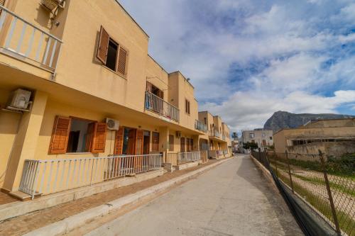 une rue vide avec des bâtiments et des montagnes en arrière-plan dans l'établissement mi casa es tu casa, à San Vito Lo Capo