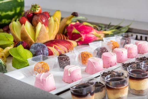 a table topped with different types of desserts and fruit at Rethymno Mare Royal & Water Park in Skaleta