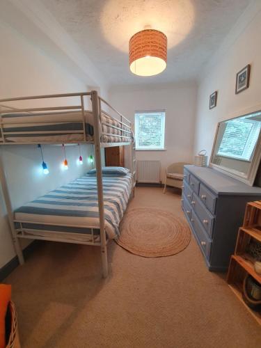 a bedroom with a bunk bed and a desk at The Annex Dymchurch in Dymchurch