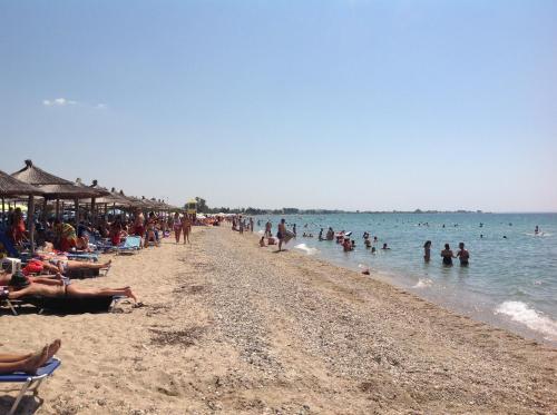 a group of people on a beach in the water at Hotel Nautilos in Sozopoli