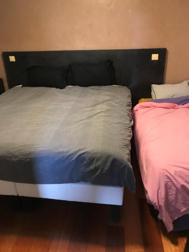 two beds sitting next to each other in a room at Résidence du bord de loire in Decize