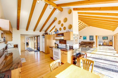 a kitchen and living room with wooden ceilings at Seascape in Sea Ranch