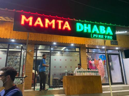 a man in front of a manilla dharma store at Hotel Young Mamta in Srinagar