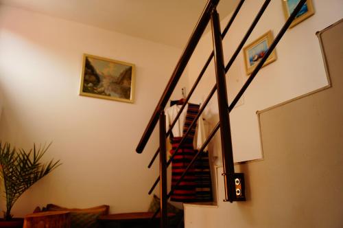 a staircase in a living room with a stair case at Guest House Dara in Tsarevo