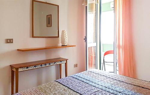 a bedroom with a bed and a mirror and a window at 1 Bedroom Beautiful Apartment In Gallipoli in Foča