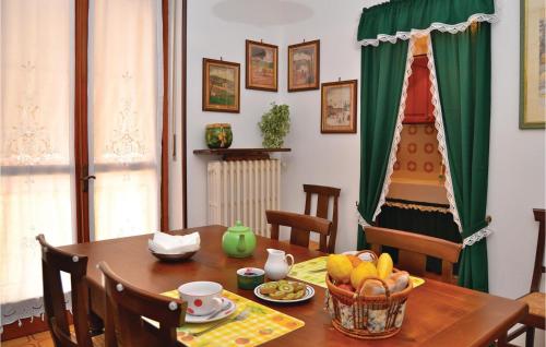 a dining room table with a bowl of fruit on it at Le Rocche 1 in Cisterna dʼAsti
