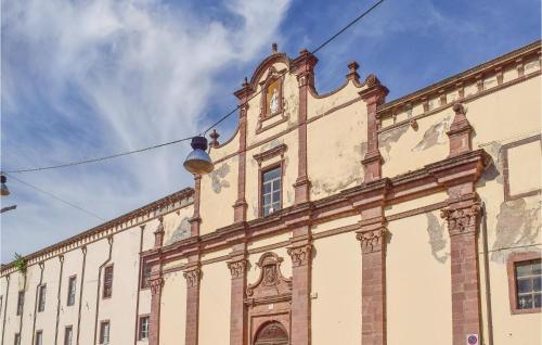 a large building with a clock on the top of it at Casa Cubo in Flussio