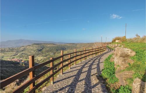 a fence on the side of a dirt road at Casa Cubo in Flussio