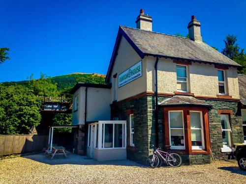 a building with two bikes parked outside of it at Denton House Hostel in Keswick