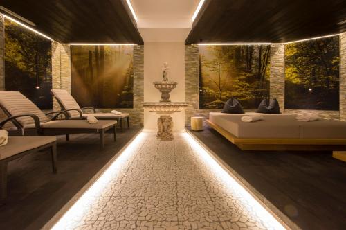 a bedroom with two beds and chairs and a fireplace at ... mein romantisches Hotel Toalstock in Fiss