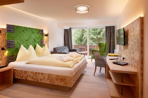 מיטה או מיטות בחדר ב-Genusshotel Fichtenhof