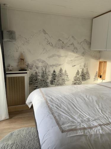 a bedroom with a mountain mural on the wall at Le Marquis Courchevel in Courchevel