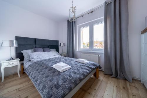 een slaapkamer met een bed met twee handdoeken erop bij Apartament Rosa in Szklarska Poręba