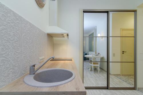a bathroom with a round sink in a room at M.K. Čiurlionis 7 in Vilnius