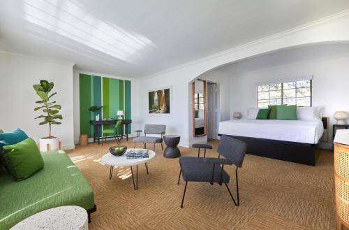 a bedroom with a bed and a living room at Descanso Resort, A Men's Resort in Palm Springs