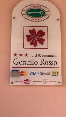 a sign for a hotel and restaurant gemeria rocas at Hotel Geranio Rosso in Stintino