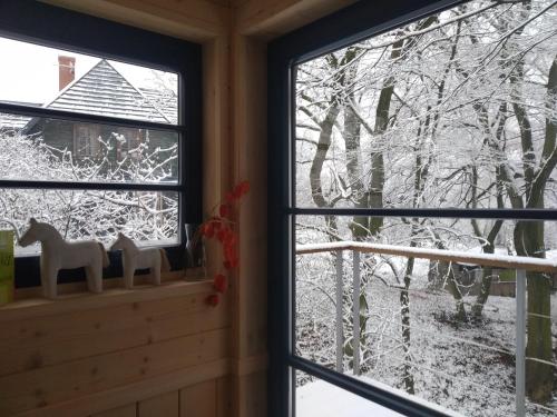 a window with a view of a snow covered tree at Węgiełek Treehouse in Kazimierz Dolny