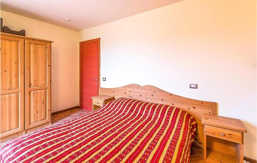 a bedroom with a large bed with a striped blanket at Trilo Stallelunghe C01 in Frabosa Sottana