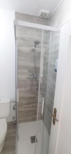 a shower stall in a bathroom with a toilet at Prau Riu Hotel Hyundai-Asturdai in Llanes