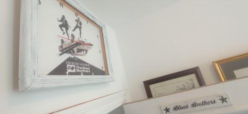 a picture hanging on a wall with pictures on it at Prau Riu Hotel Hyundai-Asturdai in Llanes