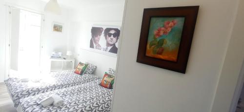 a room with a bed and a painting on the wall at Prau Riu Hotel Hyundai-Asturdai in Llanes