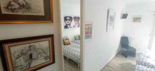 a hallway with a mirror and a picture of a bedroom at Prau Riu Hotel Hyundai-Asturdai in Llanes