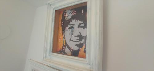 a painting of a woman in a window at Prau Riu Hotel Hyundai-Asturdai in Llanes