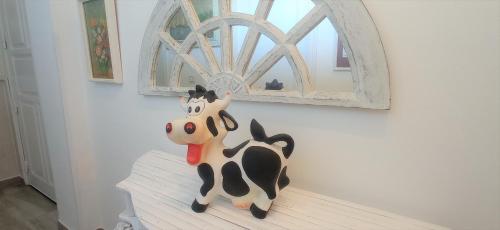 a toy cow sitting on a shelf in a room at Prau Riu Hotel Hyundai-Asturdai in Llanes