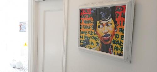 a painting of a woman hanging on a wall at Prau Riu Hotel Hyundai-Asturdai in Llanes