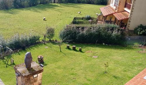an aerial view of a yard with sheep in the grass at Prau Riu Hotel Hyundai-Asturdai in Llanes