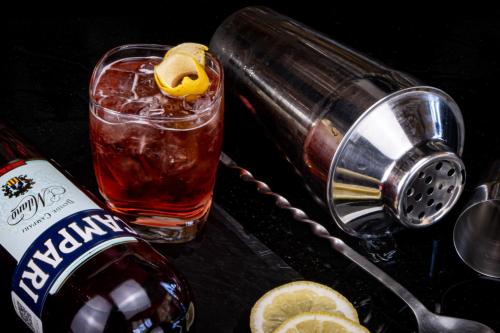 a drink in a glass next to a bottle of alcohol at TRYP by Wyndham San Luis Potosi Hotel & Suites in San Luis Potosí