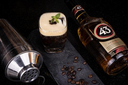 a bottle of beer next to a glass of coffee at TRYP by Wyndham San Luis Potosi Hotel & Suites in San Luis Potosí