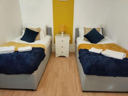 two beds sitting next to each other in a bedroom at Cheerful Gem of Barking & Dagenham 3 Bedroom House Entire Property in Goodmayes