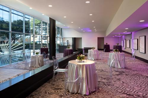 a banquet hall with tables and chairs in a building at Hyatt Regency Houston West in Houston