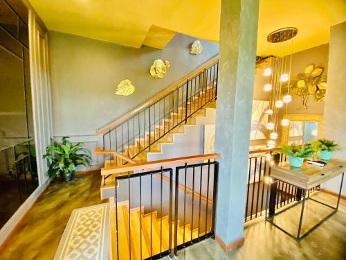 a hallway with a staircase in a house at Faizal Madhi Homestay in Kuching