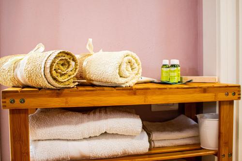 a pile of towels on a wooden shelf at Sweet Harbour PORTO - Affittacamere in Pesaro